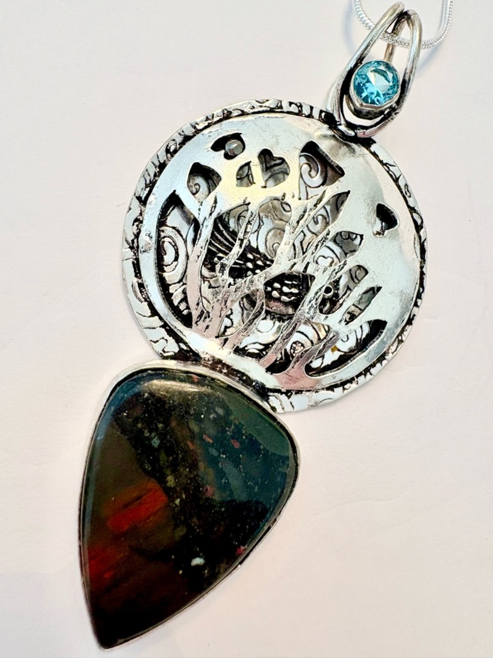2 1/2 inch, African Bloodstone and Blue Topaz, pendant with bird inside.